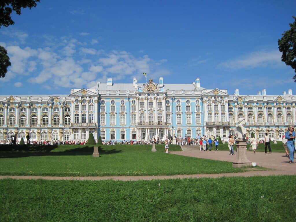 Exterior of Catherine's Palace in St. Petersburg, Russia on a sunny day with blue sky and wispy clouds.