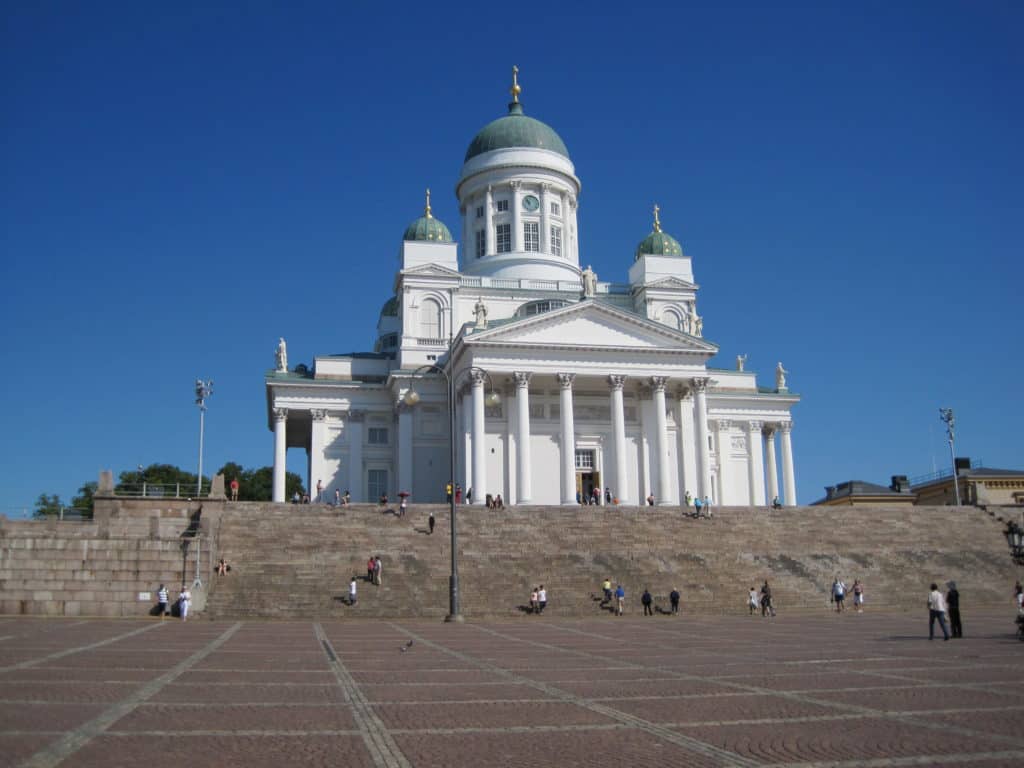 Tuomikirkko in Helsinki set against cloudless dark blue sky.