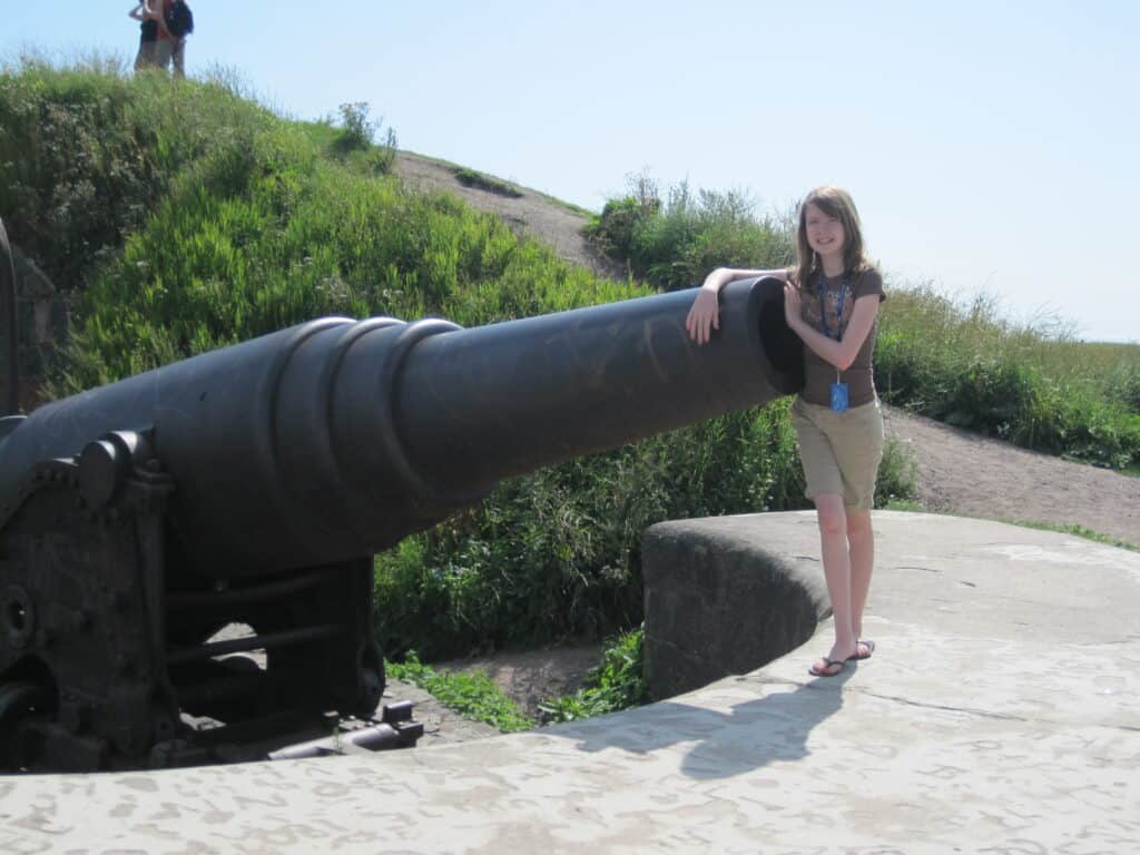 Young girl posing with cannon at Suomenlinna Fortress.