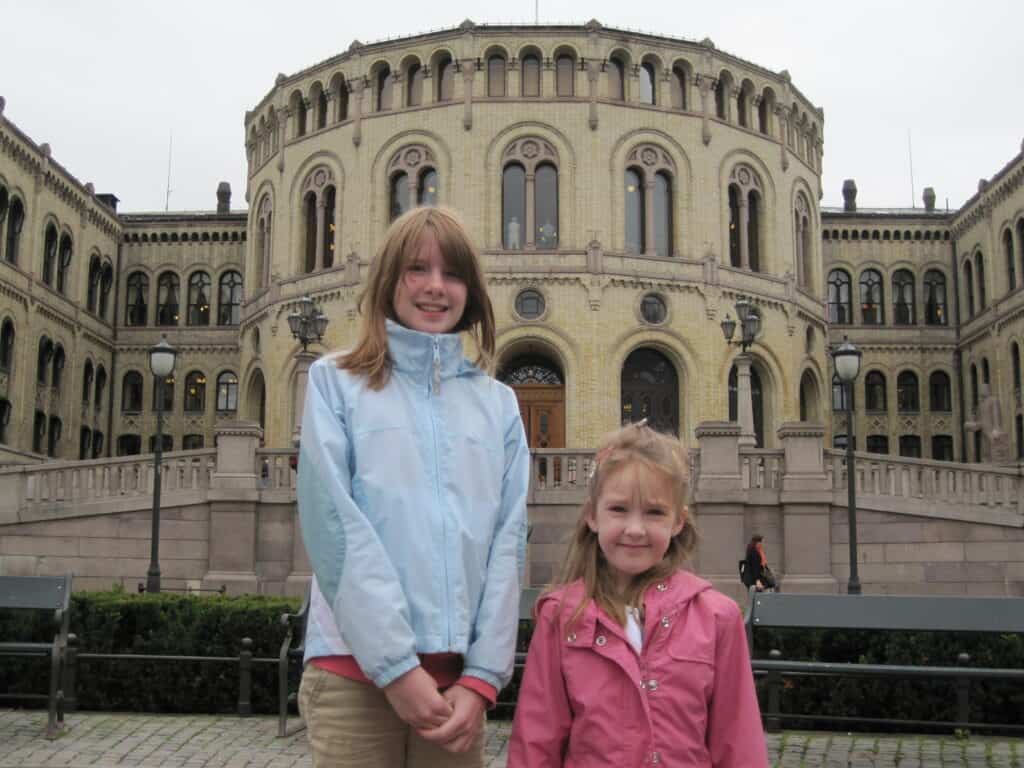 Two girls standing outside Stortinget in Oslo, Norway.