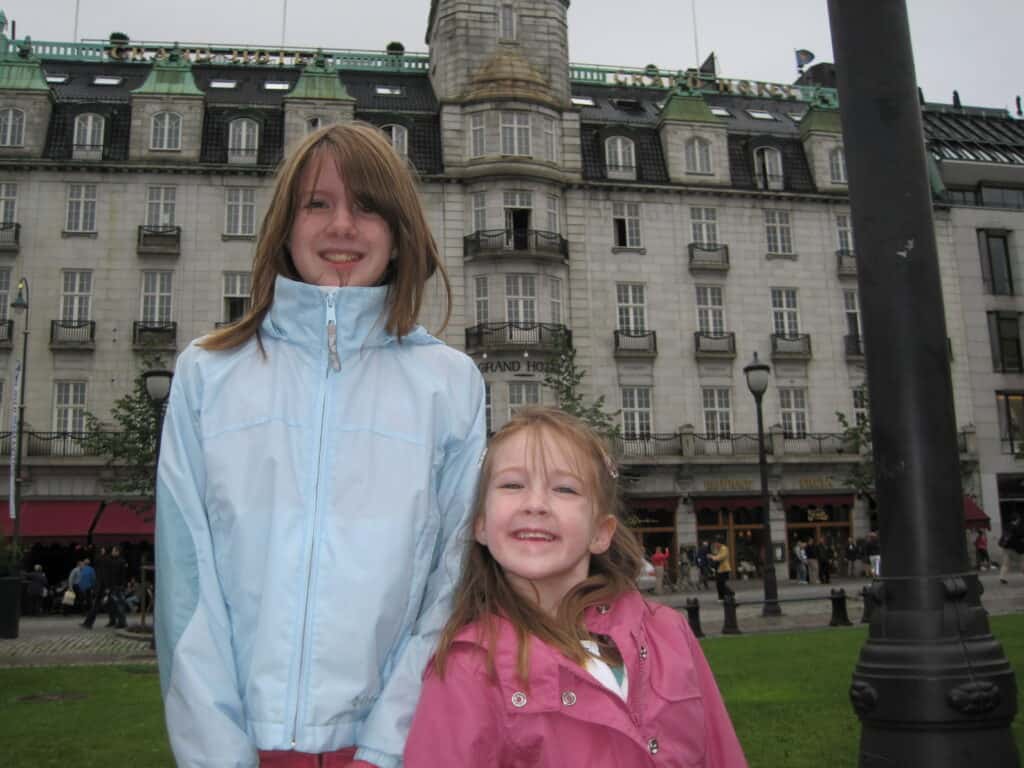 Two girls standing outside the Grand Hotel in Oslo, Norway.