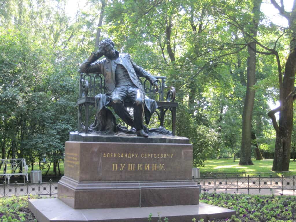 Pushkin monument in the town of Pushkin near Catherine's Palace - poet as a young man sitting on a bench.