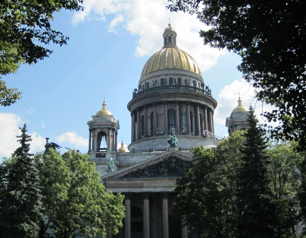 View of St. Isaac's Cathedral through trees in nearby park, St. Petersburg, Russia.