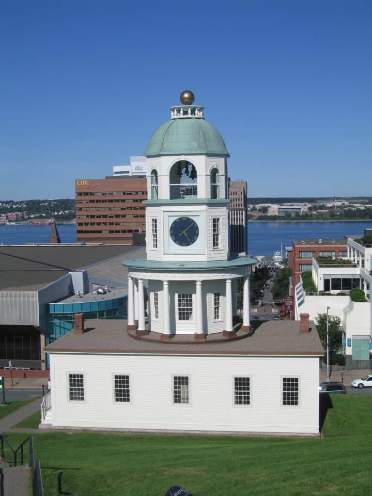 The Citadel Clock Tower in Halifax with buildings and harbour in background.