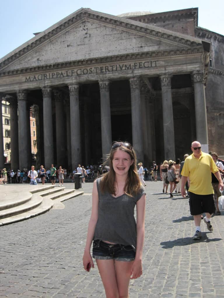 teenage girl standing outside the pantheon in rome.