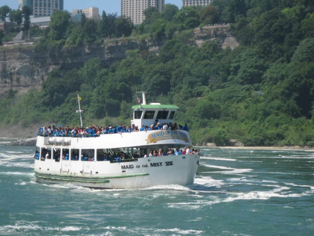 Maid of the Mist tour boat sailing toward Horseshoe Falls in Niagara Falls.