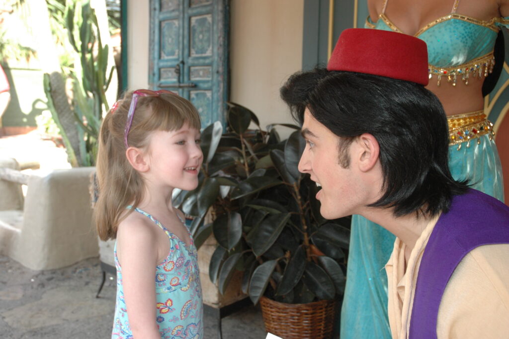 Young girl talking to Aladdin at Disney World.