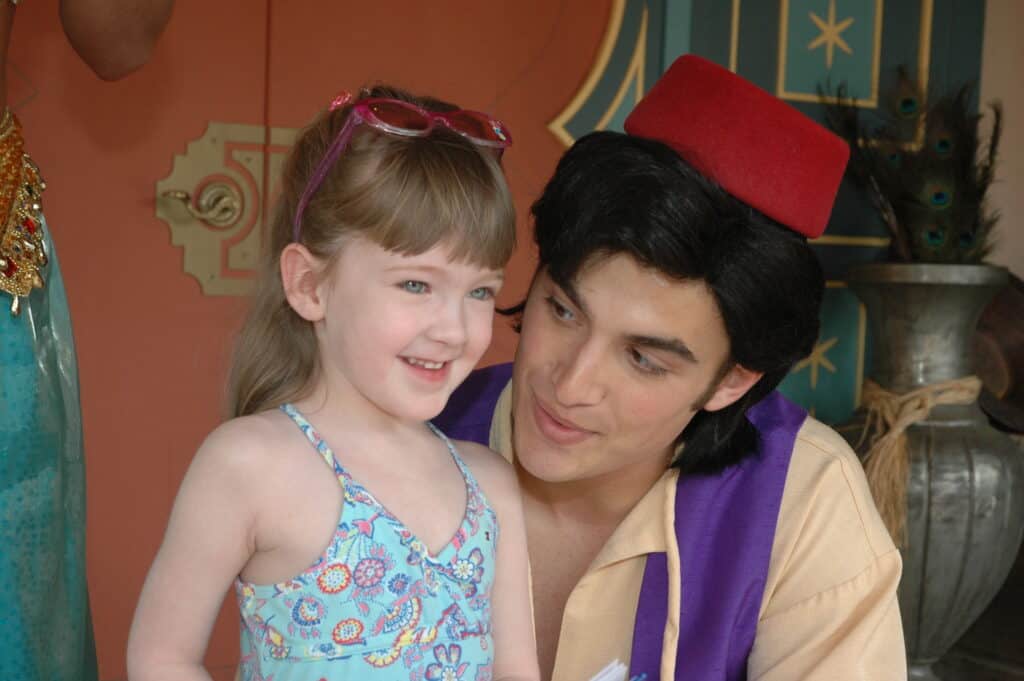 Aladdin and young girl talking at Disney World.