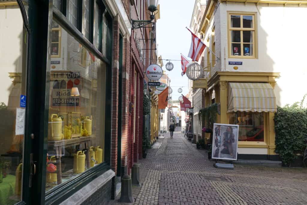 Narrow street of shops in Alkmaar, Netherlands.