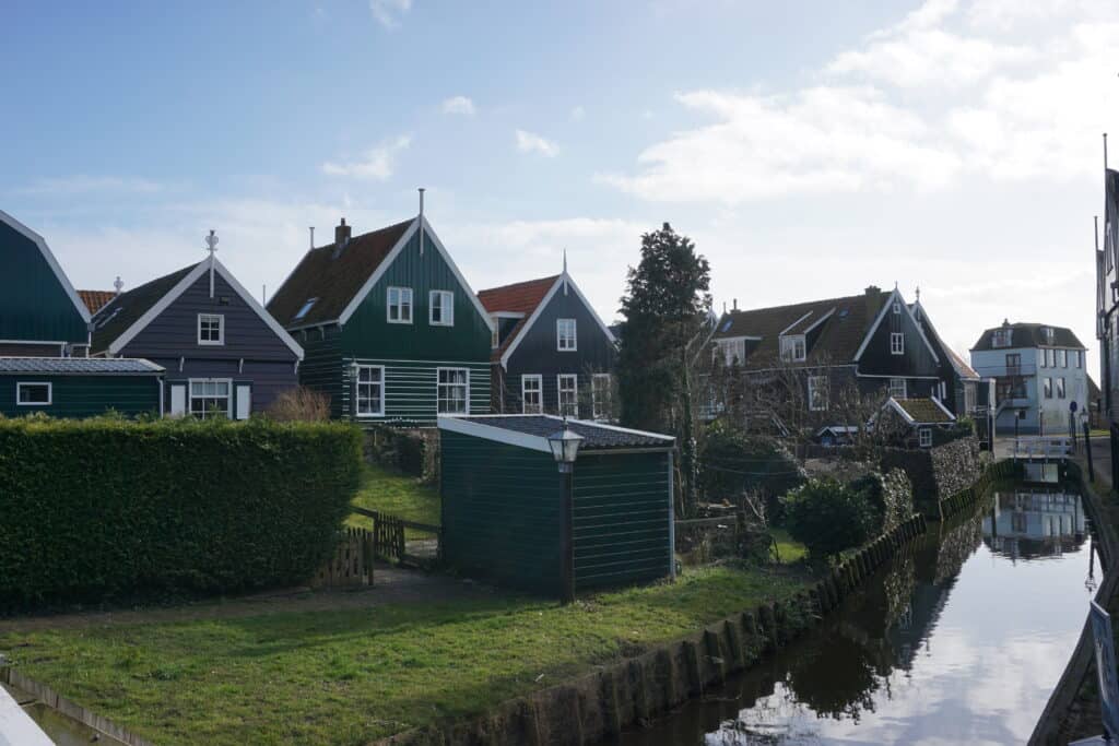 Painted houses along small canal in Marken, Netherlands.