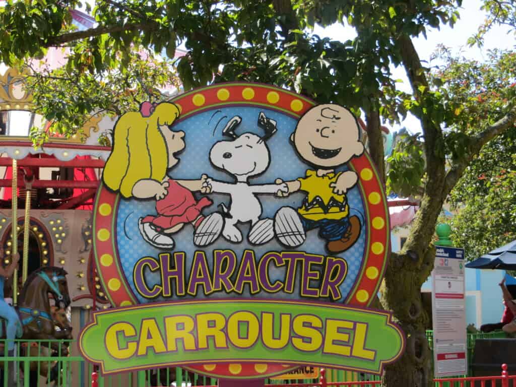 Sign with Sally, Snoopy and Charlie Brown dancing above words "Character Carrousel" at Canada's Wonderland.