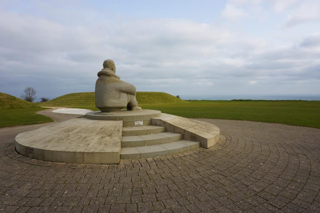 Battle of Britain Memorial site - sculpture of male pilot seated on platform looking out to sea.