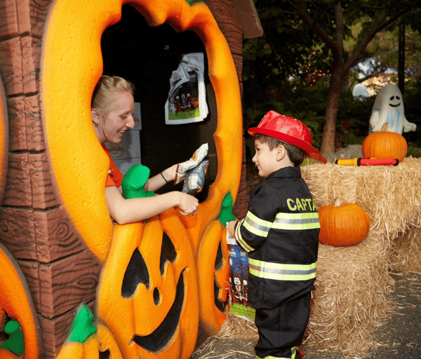 Young boy in firefighter costume trick or treating at Legoland California.