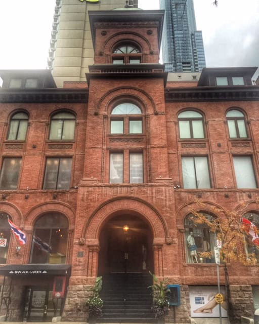 Red coloured stone exterior of Elmwood Spa building in Toronto.