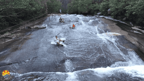 People on natural waterslide - sliding rock - in Asheville, North Carolina.