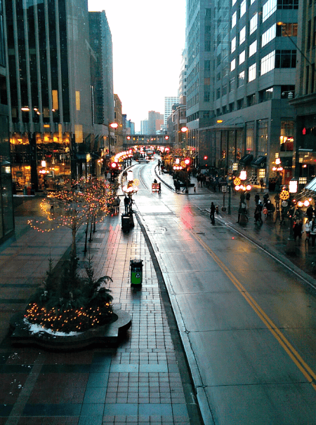 Street in downtown Minneapolis at dusk with lights during Christmas season.