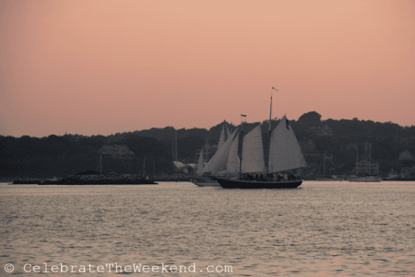 Large sailboat in Newport, Rhode Island harbour at sunset.