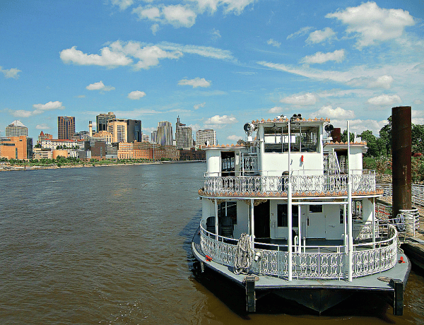 River boat docked in St. Paul, Minnesota with city skyline in background.