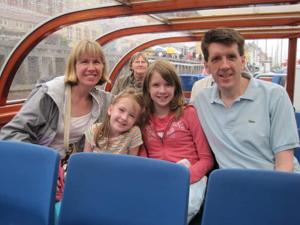 Mom, dad and two daughters on a canal tour boat in Copenhagen.