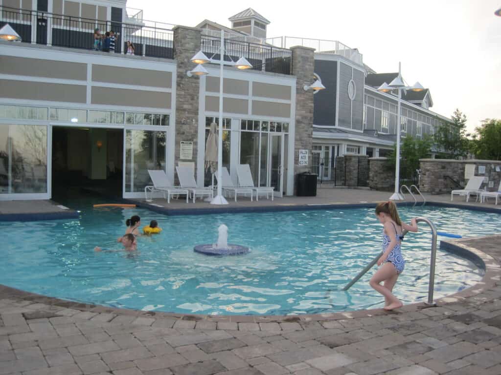 Young girl entering outdoor portion of indoor/outdoor pool at The Rosseau Muskoka.
