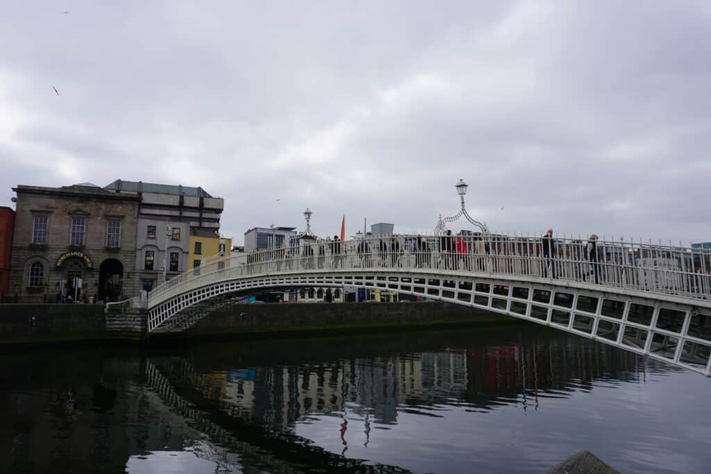 Dublin's Ha'Penny bridge over the River Liffey on an overcast day.