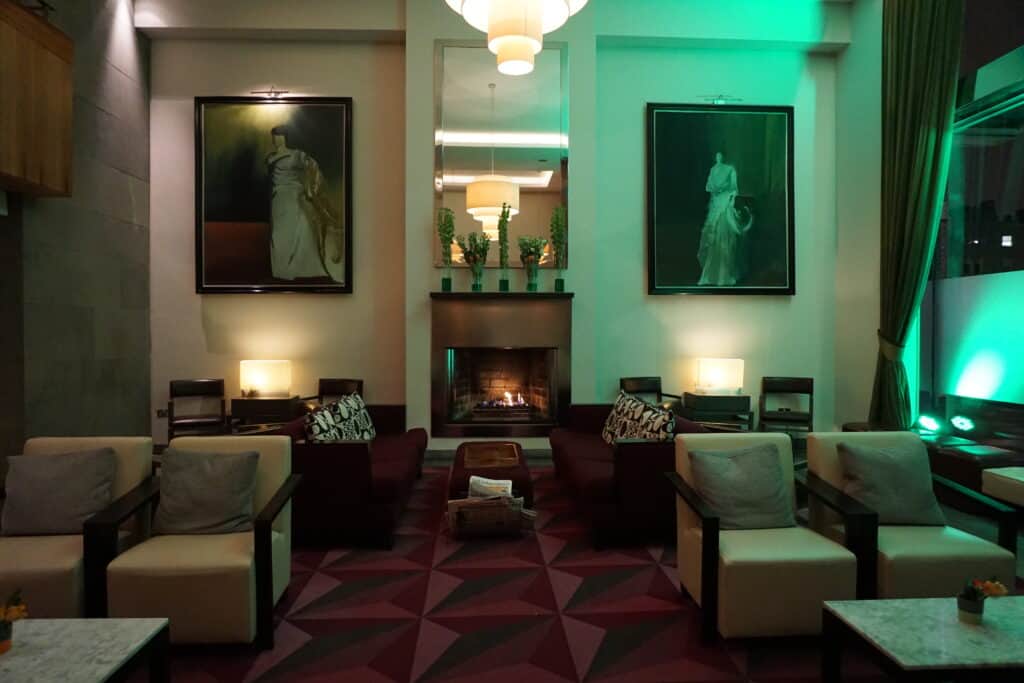Seating area by fireplace in lobby of Fitzwilliam Hotel, Dublin.