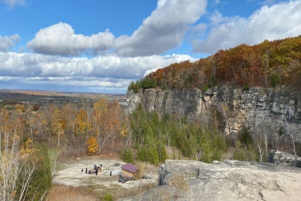 View of Niagara Escarpment at Kelso Conservation Area in fall with orange and yellow leaves.