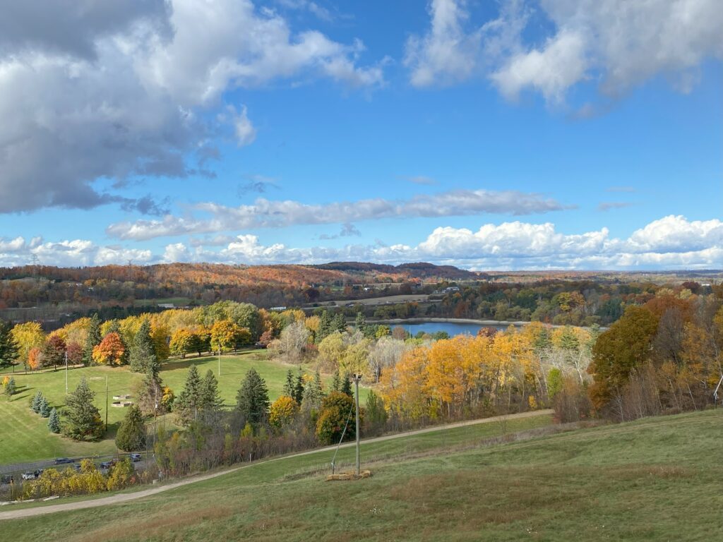 view of colourful trees and reservoir taken while riding the chairlift down at Kelso Conservation Area.